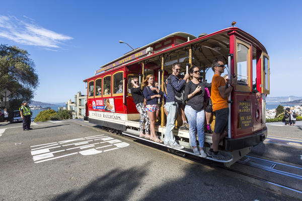 People riding the cable car. San Francisco, Marin County, California, USA.