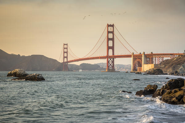 Golden Gate Bridge at sunset shot from Baker Beach. San Francisco, Marin County, California, USA.