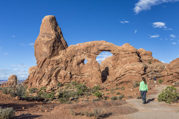 Woman on the path to Turret Arch. Arches National Park, Moab, Grand County, Utah, USA.