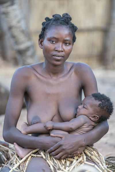 Mafwe woman breastfeeding her son. Mafwe Living Museum, Zambesi region, Namibia.