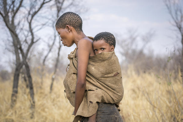 Mother and son in Bushman Hunters Living History Village. Grashoek, Otjozondjupa, Namibia, Africa.