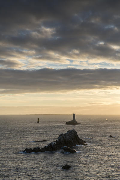 Vieille lighthouse from Raz point at sunset. Plogoff, Finistère, Brittany, France.