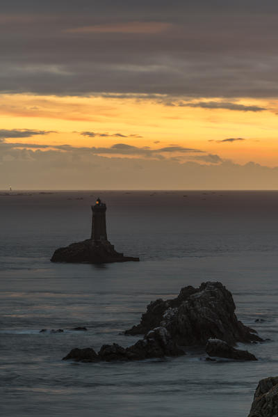 Vieille lighthouse from Raz point at sunset. Plogoff, Finistère, Brittany, France.