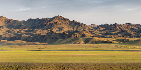 Nomadic camp with livestock and mountains in the background. Bayandalai district, South Gobi province, Mongolia.