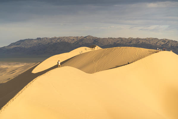 People walking on Khongor sand dunes in Gobi Gurvan Saikhan National Park. Sevrei district, South Gobi province, Mongolia.