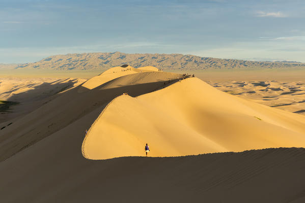 People walking on Khongor sand dunes in Gobi Gurvan Saikhan National Park. Sevrei district, South Gobi province, Mongolia.