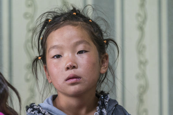 Portrait of a Mongolian little girl with pigtails. Huzirt, South Hangay province, Mongolia.