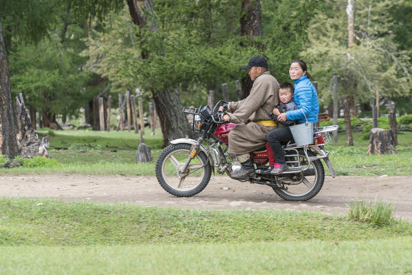 Mongolian nomadic family riding a motorbike. Hovsgol province, Mongolia.