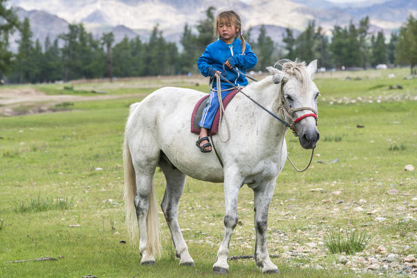 Mongolian nomadic little girl riding a horse. Hovsgol province, Mongolia.