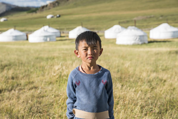 Mongolian nomadic little boy and gers in the background. Burentogtokh district, Hovsgol province, Mongolia.