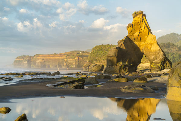 Rock formation reflect with low tide. Tongaporutu, New Plymouth district. Taranaki region, North Island, New Zealand.