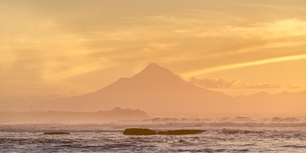 Silhouette of Mount Taranaki at sunset. Tongaporutu, New Plymouth district. Taranaki region, North Island, New Zealand.