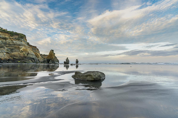 Reflections at the Three Sisters beach. Tongaporutu, New Plymouth district. Taranaki region, North Island, New Zealand.