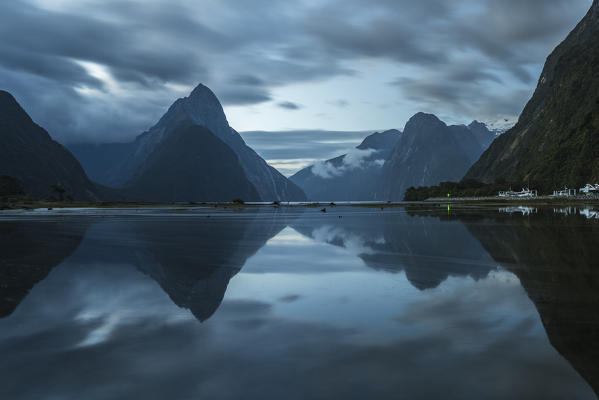 Reflection of Milford Sound at dusk in summer. Fiordland NP, Southland district, Southland region, South Island, New Zealand.