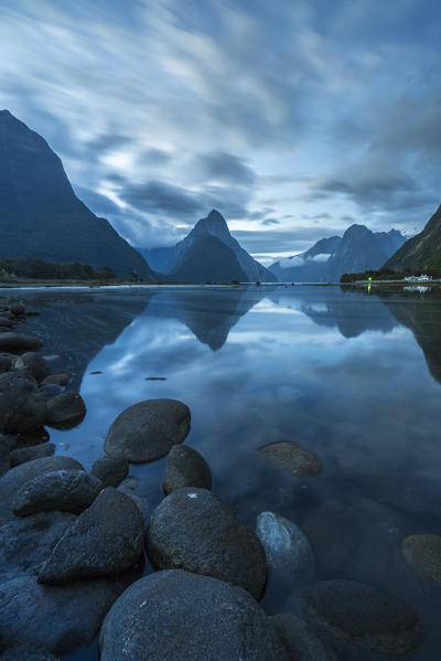 Reflection of Milford Sound at dusk in summer. Fiordland NP, Southland district, Southland region, South Island, New Zealand.