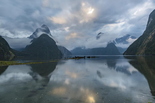 Reflection of Milford Sound at sunset in summer. Fiordland NP, Southland district, Southland region, South Island, New Zealand.