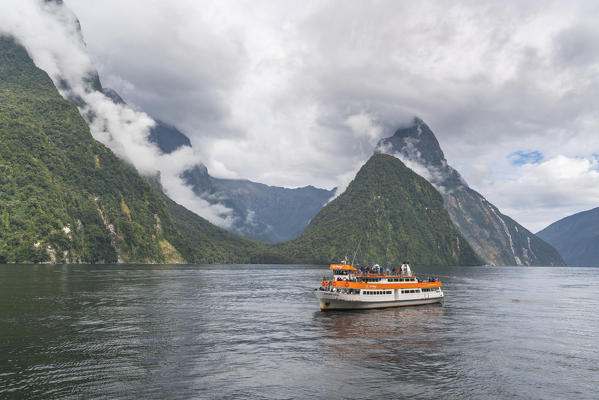 Touristic boat cruising in Milford Sound. Fiordland NP, Southland district, Southland region, South Island, New Zealand.