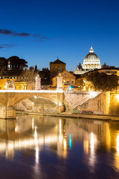Rome at dusk with view of the dome of Saint Peter's Basilica, Octagonal Tower of the  church of the holy spirit in the saxon district and Tiber River
Europe, Italy, Lazio, Province of Rome, Rome, dusk