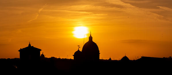 A Panoramic view of the roofs and Dome of Rome in silhouette at Sunset
Europe, Italy, Lazio Region, Province of Rome, Rome