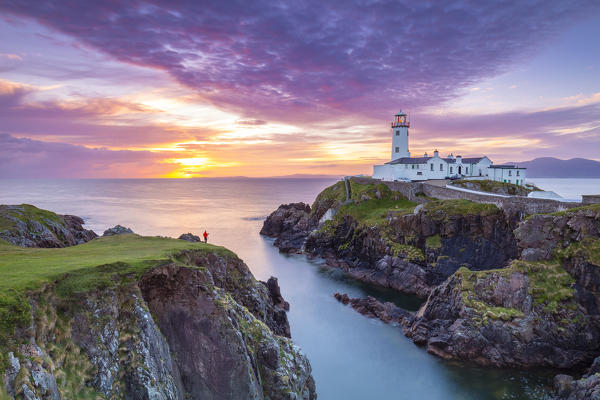 View of a photographer at the Fanad Head (Fánaid) lighthouse at sunrise, County Donegal, Ulster region, Ireland, Europe.