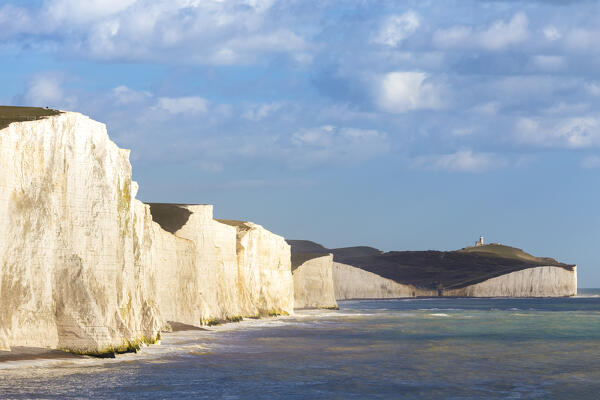 View of the Seven Sisters cliffs and the Belle Tout lighthouse, from Seaford Head across the River Cuckmere.  Seaford, Sussex, England, United Kingdom.