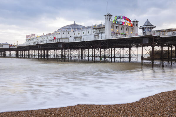 View of the Palace pier at sunset. Brighton, East Sussex, Southern England, United Kingdom.