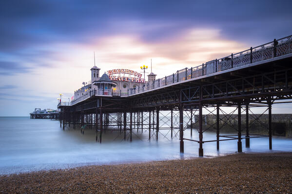 View of the Palace pier at sunset. Brighton, East Sussex, Southern England, United Kingdom.