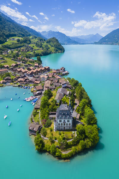 Aerial view of the village of Iseltwald and it's peninsula with the old Castle on Lake Brienz. Iseltwald, Lake Brienz, Bernese Oberland, Interlaken-Oberhasli district, Canton of Bern, Switzerland.
