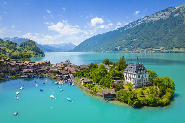 Aerial view of the village of Iseltwald and it's peninsula with the old Castle on Lake Brienz. Iseltwald, Lake Brienz, Bernese Oberland, Interlaken-Oberhasli district, Canton of Bern, Switzerland.