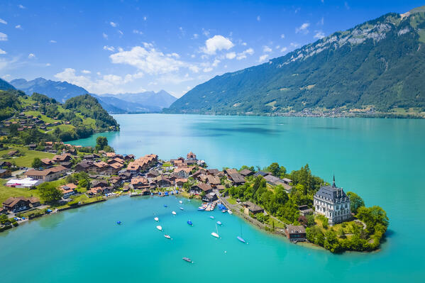 Aerial view of the village of Iseltwald and it's peninsula with the old Castle on Lake Brienz. Iseltwald, Lake Brienz, Bernese Oberland, Interlaken-Oberhasli district, Canton of Bern, Switzerland.