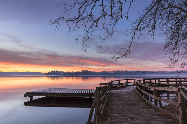 Winter sunrise on the Gavirate pier of Lago di Varese, Varese Province, Lombardy, Italy.