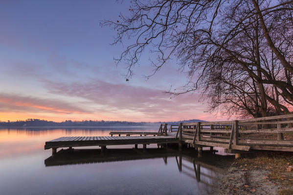Winter sunrise on the Gavirate pier of Lago di Varese, Varese Province, Lombardy, Italy.