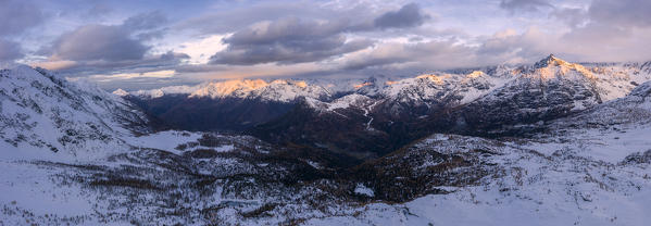 Panoramic of the snowy peaks of Sasso Moro and Monte Disgrazia at dawn, Malenco Valley, Sondrio province, Valtellina, Lombardy, Italy