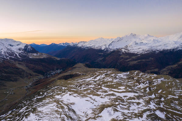 Elevated view of Madesimo and Andossi surrounded by snowy peaks, Spluga Valley, Sondrio province, Valtellina, Lombardy, Italy