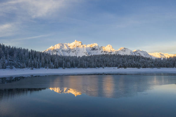 Snowy peaks mirrored in Lake Palù partially frozen, Malenco Valley, Sondrio province, Valtellina, Lombardy, Italy