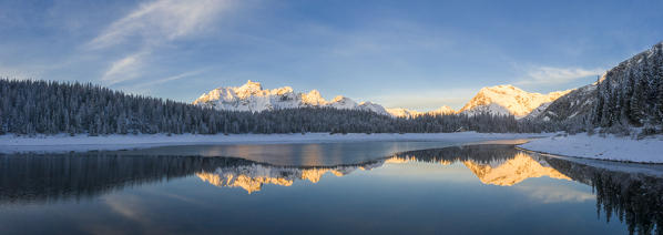 Panoramic of snowy peaks mirrored in Lake Palù at dawn, Malenco Valley, Sondrio province, Valtellina, Lombardy, Italy