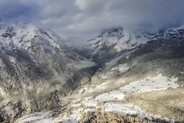 Alpine villages and woods covered with snow, valley of Chiareggio, Malenco Valley, Sondrio province, Valtellina, Lombardy, Italy