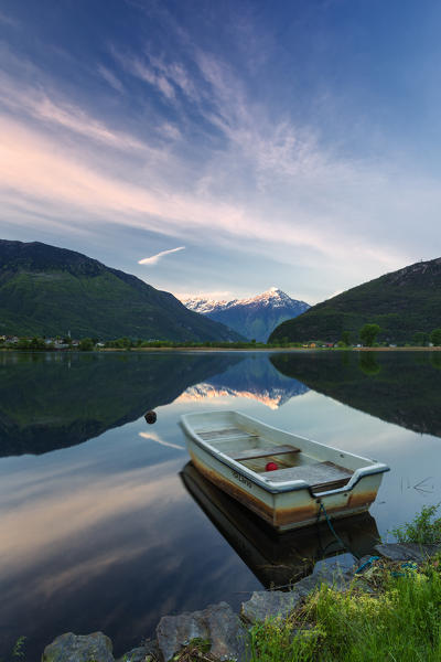 Boat moored in lake of Novate Mezzola at sunrise, Valchiavenna, Sondrio province, Valtellina, Lombardy, Italy
