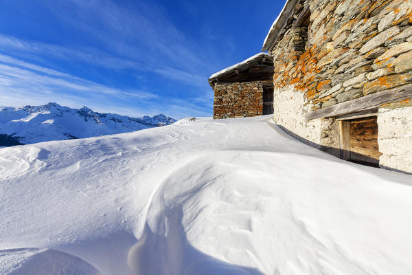 Stone huts in deep snow, Alpe Groppera, Madesimo, Valchiavenna, Valtellina, Sondrio province, Lombardy, Italy