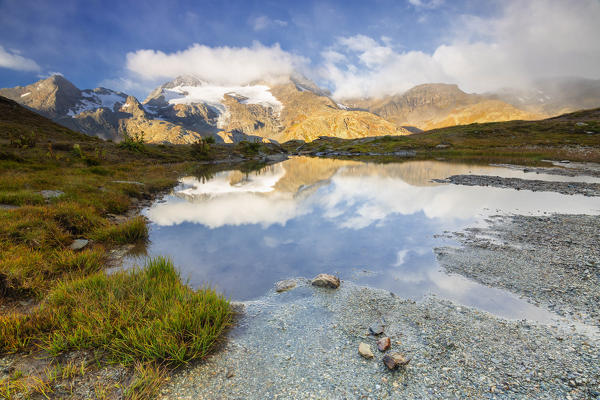 Piz Cambrena mirrored in the alpine lake, Val Dal Bugliet, Bernina Pass, canton of Graubunden, Engadine, Switzerland