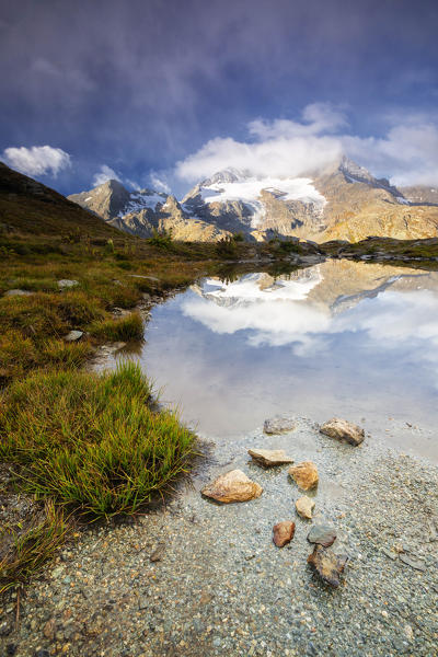 Piz Cambrena mirrored in the alpine lake, Val Dal Bugliet, Bernina Pass, canton of Graubunden, Engadine, Switzerland