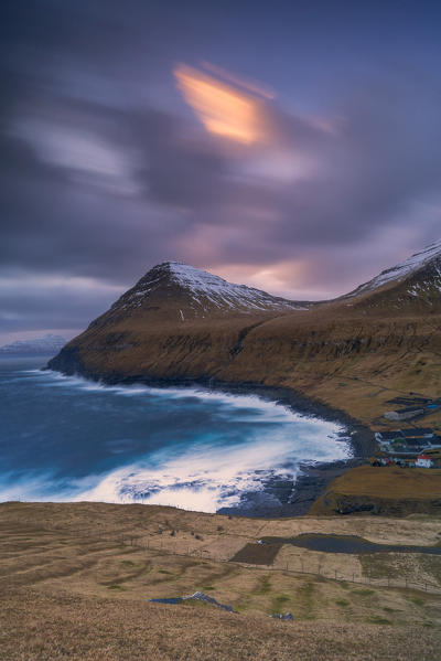Cloudy sky at sunset over the coastal village of Gjogv, Eysturoy island, Faroe Islands, Denmark