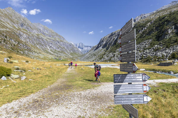 Fathers and children walk on footpath, Saviore dell'Adamello, Valcamonica, province of Brescia, Lombardy, Italy