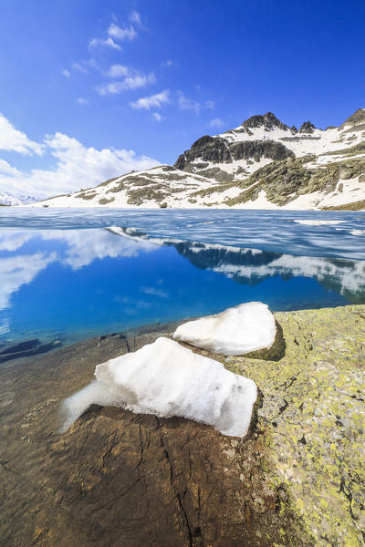 Ice blocks on the shore of alpine lake Lej da la Tscheppa during thaw, St. Moritz, Engadin, canton of Graubunden, Switzerland