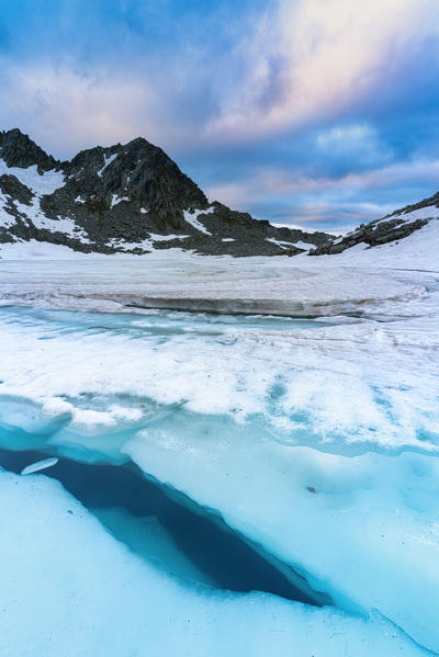 Ice melting at Lago Nero during spring thaw, Montespluga, Valchiavenna, Valle Spluga, Valtellina, Sondrio, Lombardy, Italy