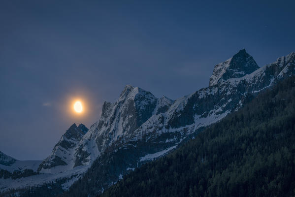 Moonlight over Pizzo Cengalo and Pizzo Badile partially snowy, Bregaglia Valley, canton of Graubunden, Switzerland