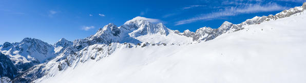 Aerial panoramic of snowy ridges of Monte Disgrazia, Valle di Chiareggio Valmalenco, Valtellina, Lombardy, Italy