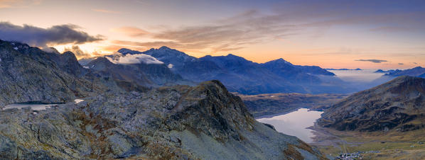 Aerial panoramic of Laghi Azzurri (Bergseeli) and Montespluga dam at dawn, Spluga Pass, Valle Spluga, Valtellina, Lombardy, Italy