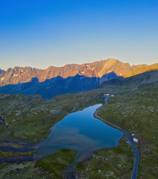 Aerial panoramic of Lago Bianco and Cima di Pietra Rossa lit by sunrise,  Gavia Pass, Valfurva, Valtellina, Lombardy, Italy