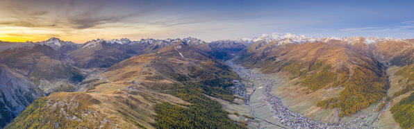 Aerial panoramic of the sky at sunrise over Livigno, Passo Foscagno and Val Federia in autumn, Valtellina, Lombardy, Italy